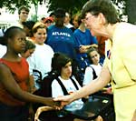Janet Reno shakes hands with girl