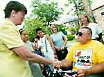Janet Reno shakes hands with man using wheelchair