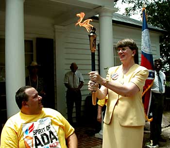 Janet Reno walks with torch