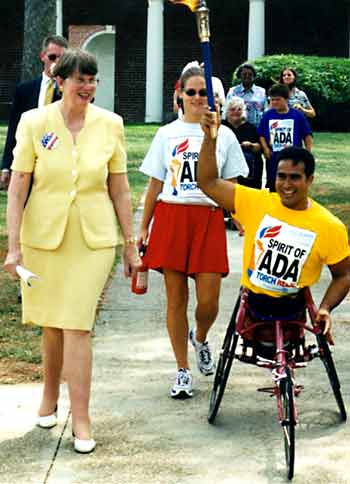 Janet Reno walks with torch carrier