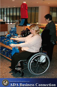A woman in a wheelchair shops for clothes, ADA business connection logo