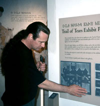 Photo:  Man who is blind examines raised-line exhibit floor plan in museum label

