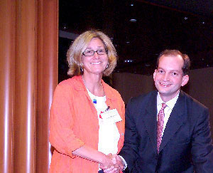 A picture of Patrica Harrinton shaking hands with AAG Acosta.