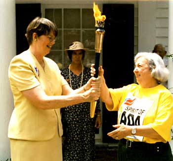 Janet Reno hands torch off to woman