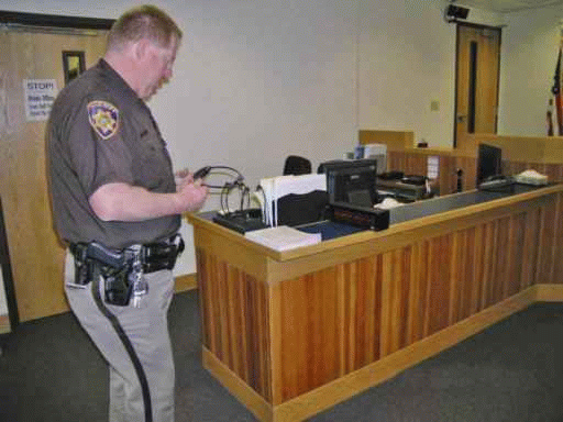 Court officer checking assistive listening devices