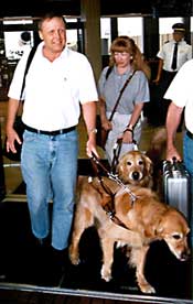 Couple using guide dogs leave airport