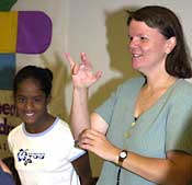 June Freeman speaks to audience using sign language