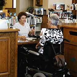photo - woman using wheelchair at desk in library