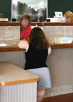 photo - woman of short stature at accessible service counter