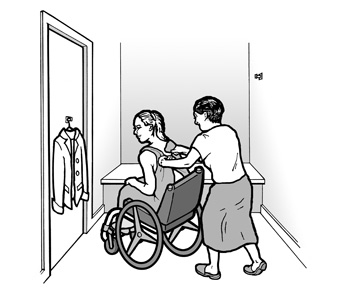 A woman using a wheelchair is trying on clothes
in a dressing room. A friend is helping her.