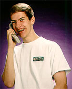 a young man is using a cordless phone