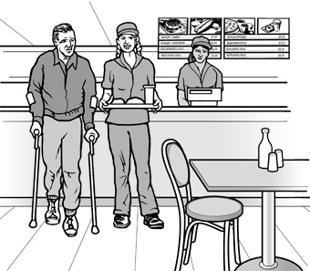 In a casual restaurant, an employee assists a
man using crutches, by carrying his tray to a table.